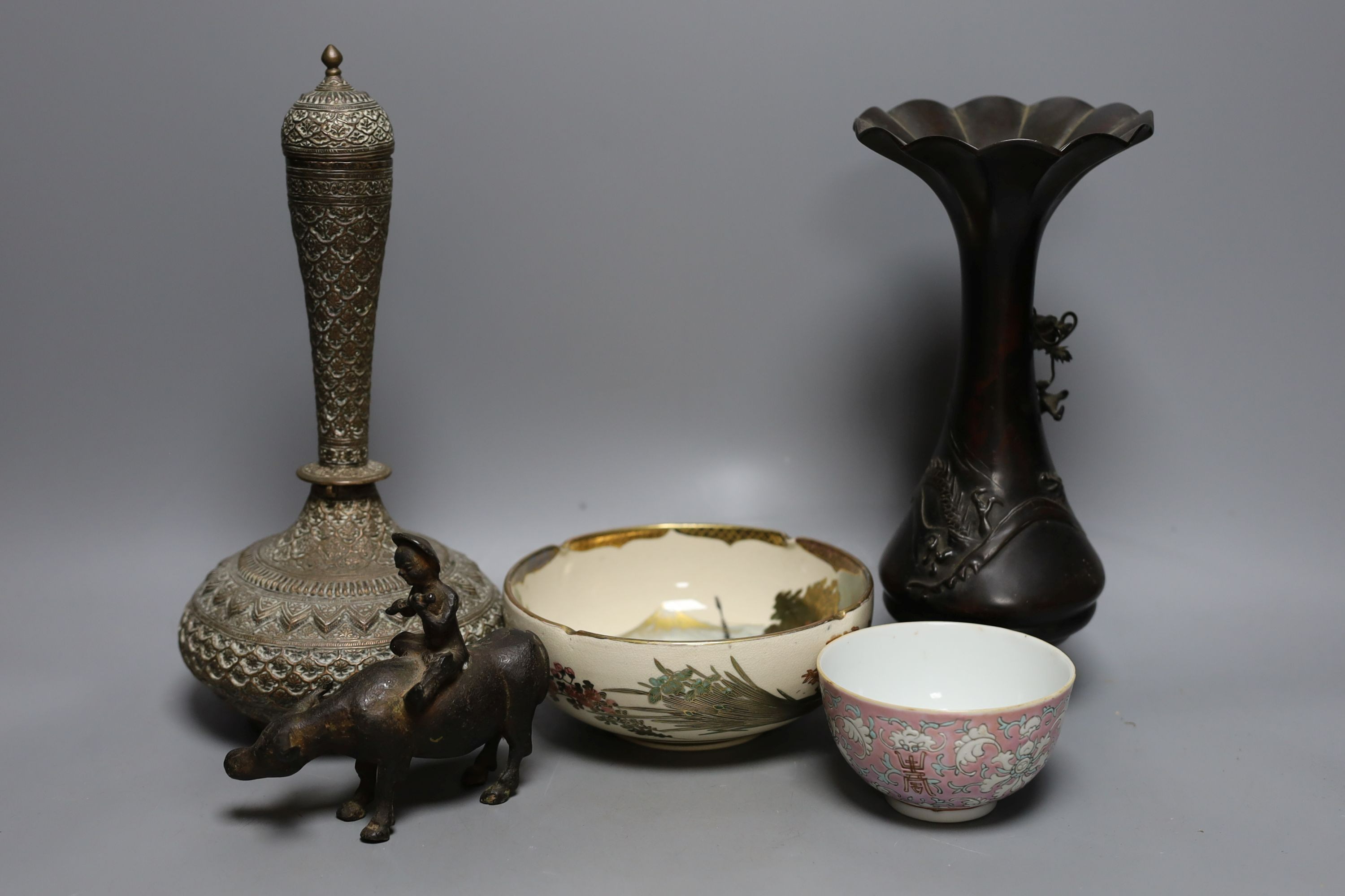 A Japanese bronze vase, an Islamic brass bottle, Chinese enamelled porcelain bowl, bronze group of man riding an ox. 29cm